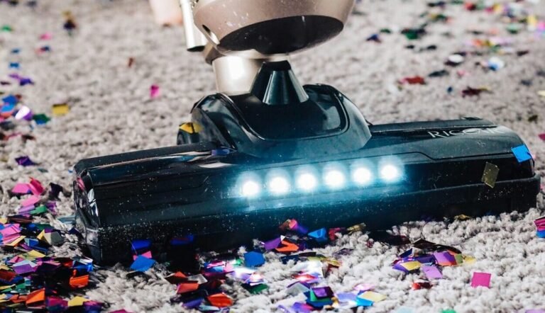 a person using a vacuum to clean a carpet