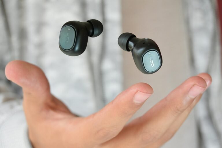 A Person Tossing the Qcy Earbuds in the Air